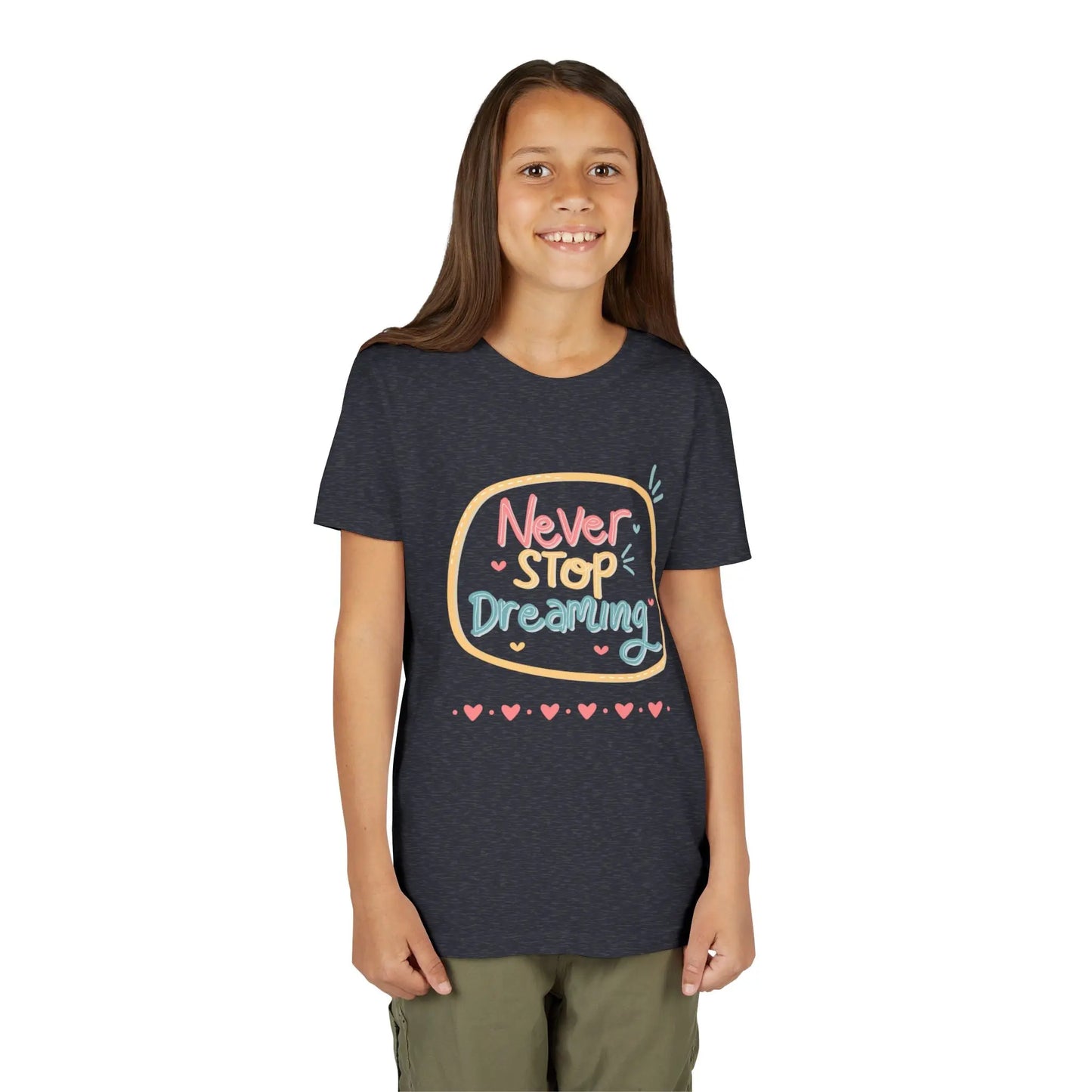 Youth wearing this encouraging youth tee with "Never Stop Dreaming" message. Soft cotton, perfect for school, everyday wear, and inspiring creativity. Motivational kids' clothing. Heather Navy