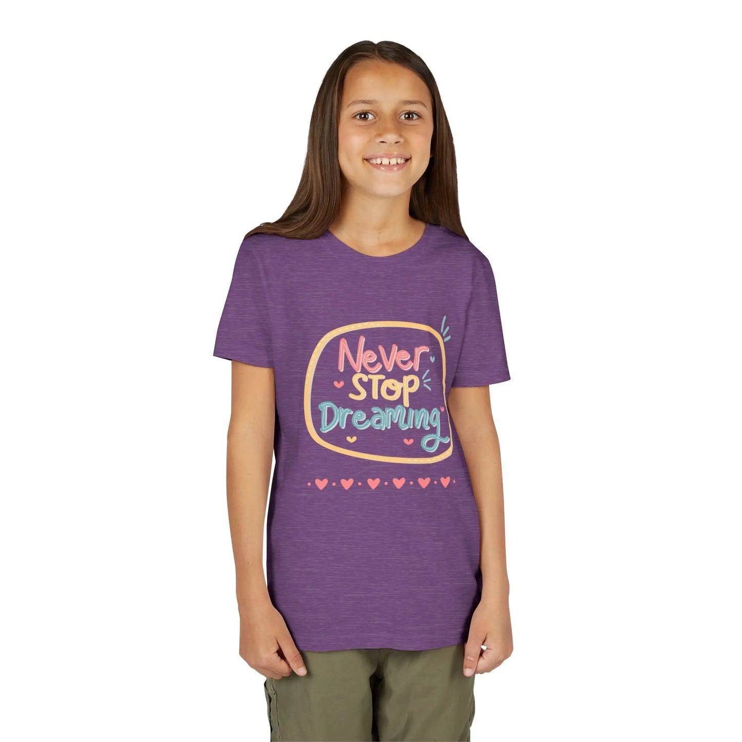 Youth wearing this encouraging youth tee with "Never Stop Dreaming" message. Soft cotton, perfect for school, everyday wear, and inspiring creativity. Motivational kids' clothing. Heather Team Purple