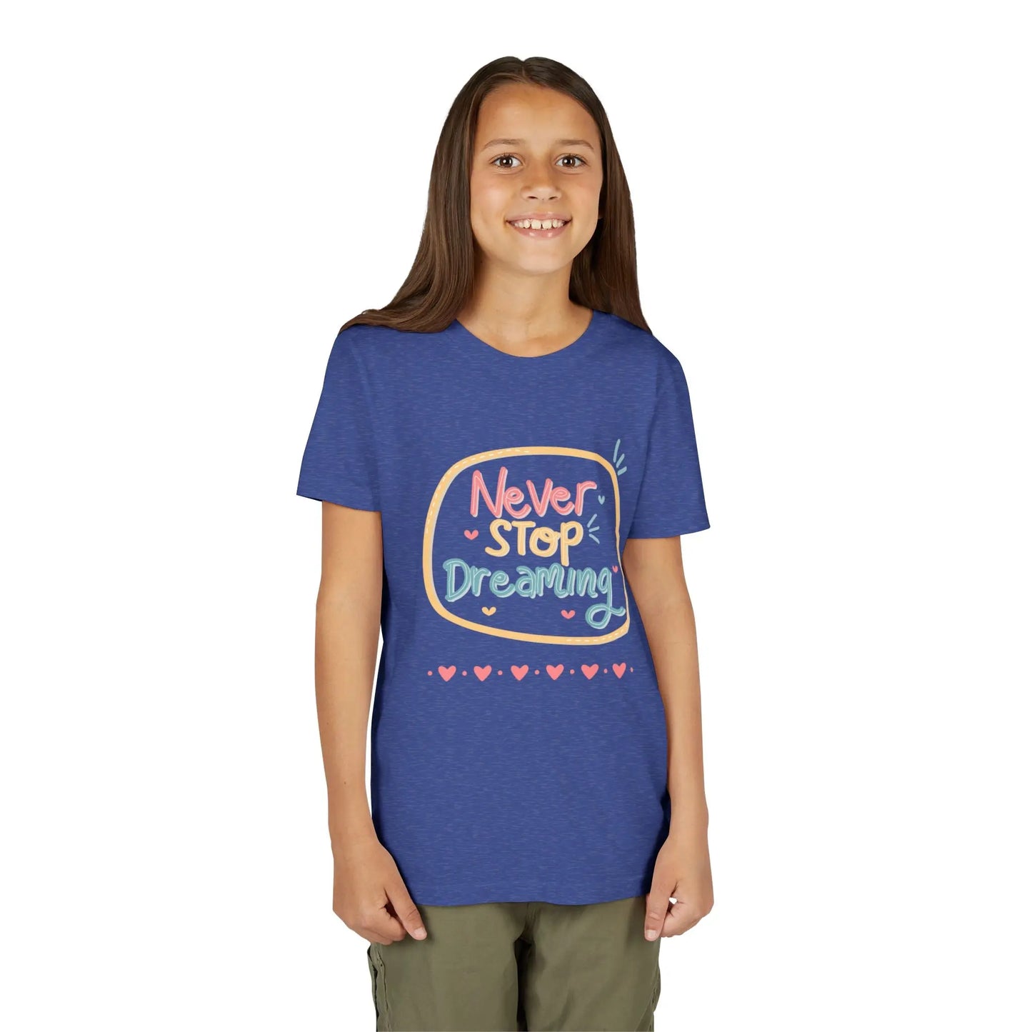Youth wearing this encouraging youth tee with "Never Stop Dreaming" message. Soft cotton, perfect for school, everyday wear, and inspiring creativity. Motivational kids' clothing. Heather True Royal