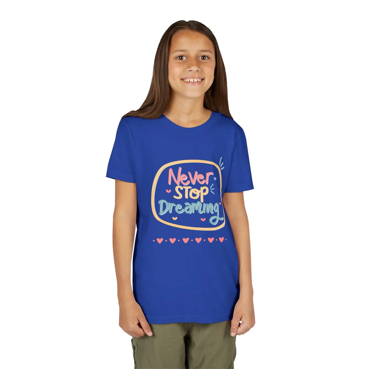 Youth wearing this encouraging youth tee with "Never Stop Dreaming" message. Soft cotton, perfect for school, everyday wear, and inspiring creativity. Motivational kids' clothing. True Royal