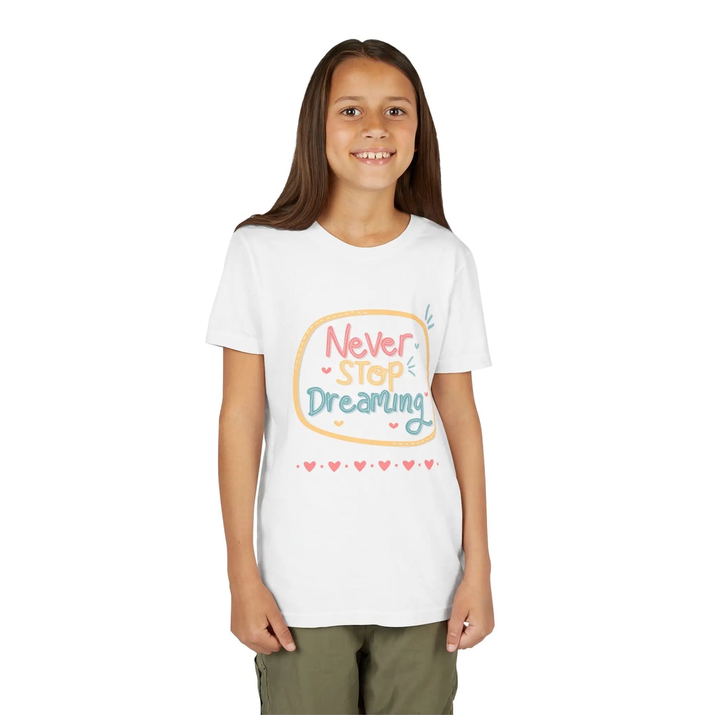 Youth wearing this encouraging youth tee with "Never Stop Dreaming" message. Soft cotton, perfect for school, everyday wear, and inspiring creativity. Motivational kids' clothing. White