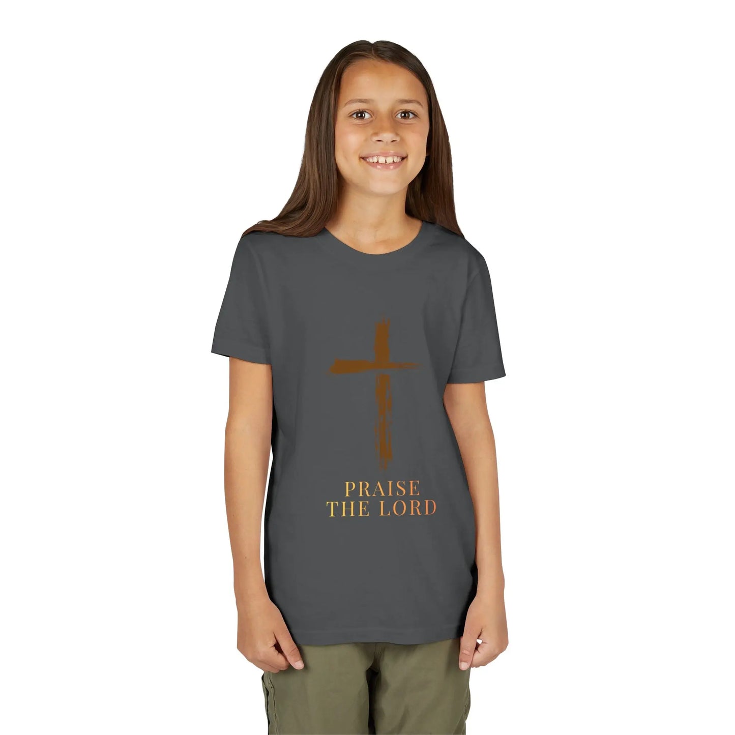 Girl wearing a Girl wearing a soft, faith-inspired youth tee featuring a painterly brushstroke cross and "Praise The Lord." Perfect for church, Sunday school, Easter, and everyday Christian wear. Asphalt