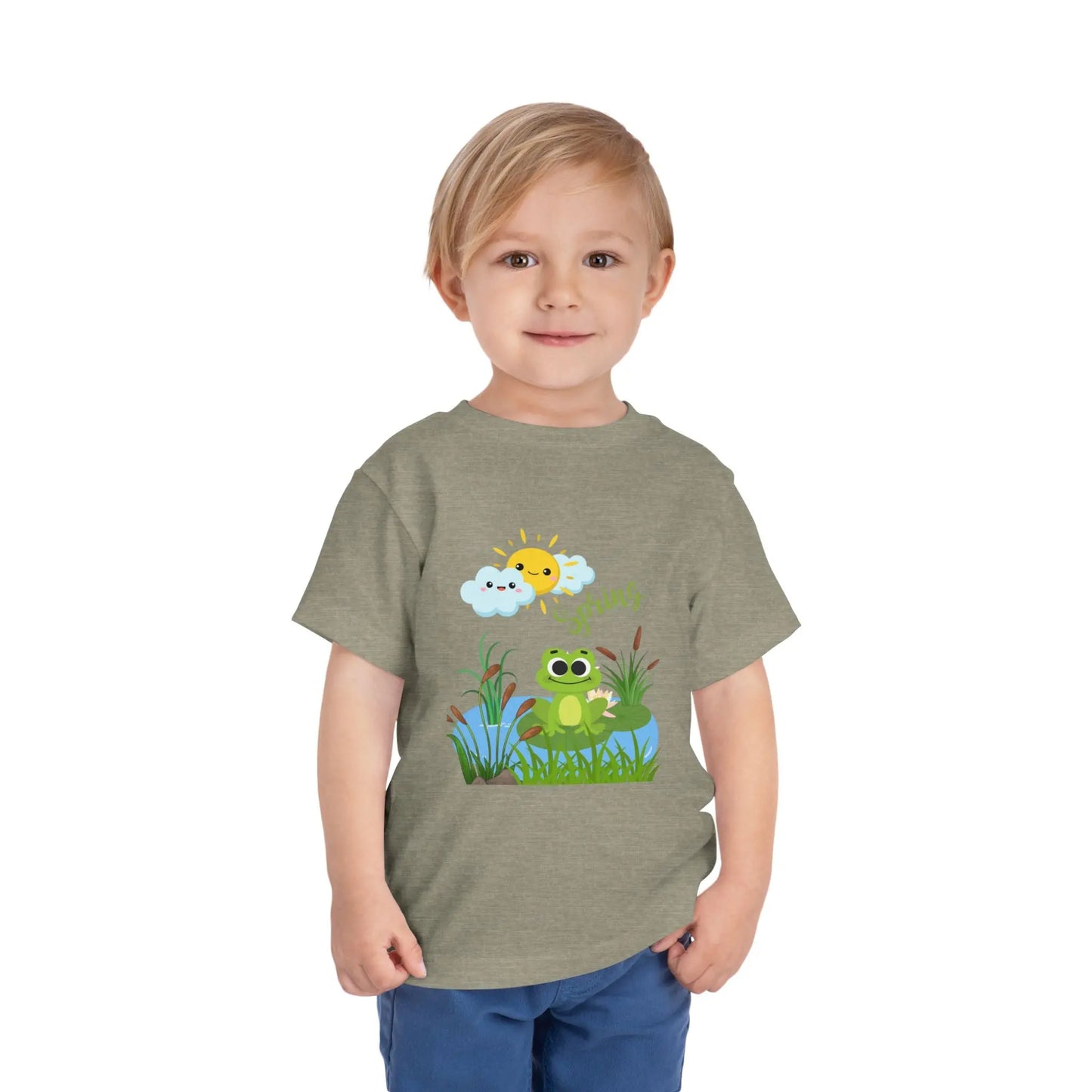 Toddler wearing an adorable toddler tee with spring frog pond graphic. Soft cotton, perfect for Easter, spring outfits, and playful adventures. Cute kids' clothing for toddlers. Heather Stone