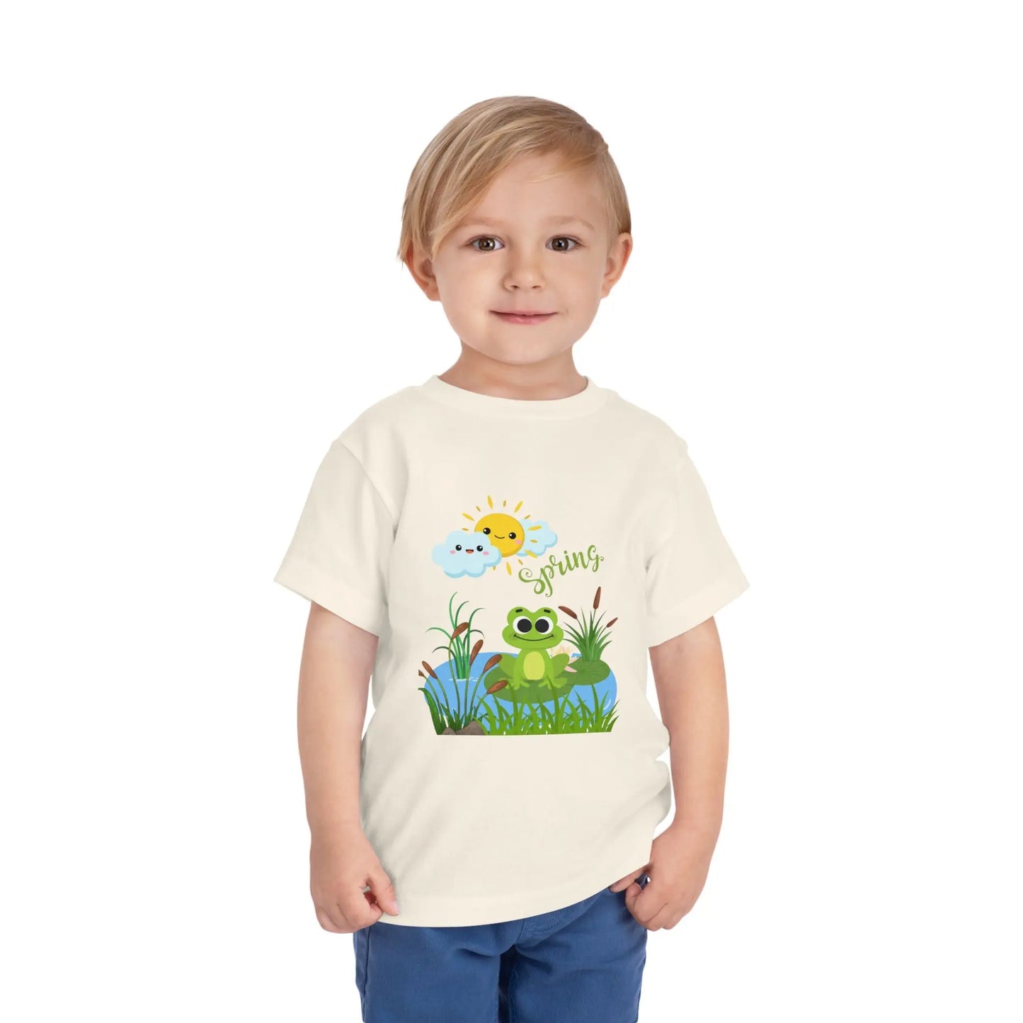 Toddler wearing an adorable toddler tee with spring frog pond graphic. Soft cotton, perfect for Easter, spring outfits, and playful adventures. Cute kids' clothing for toddlers. Natural