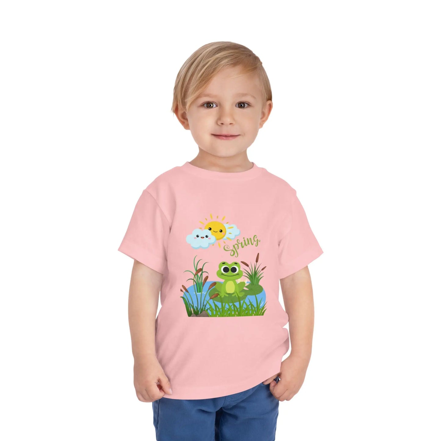 Toddler wearing an adorable toddler tee with spring frog pond graphic. Soft cotton, perfect for Easter, spring outfits, and playful adventures. Cute kids' clothing for toddlers. Pink