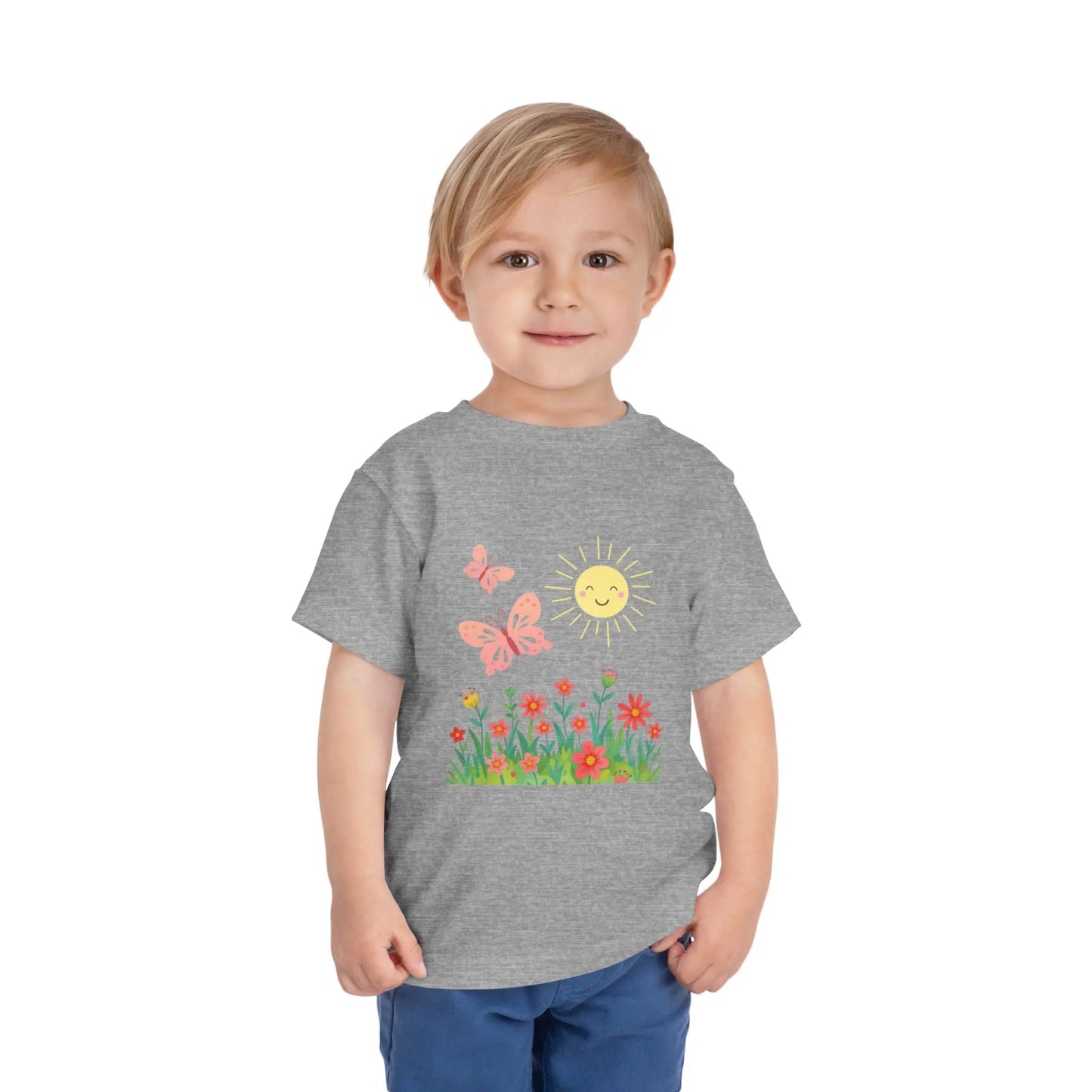 Toddler wearing a cheerful toddler tee with smiling sun, butterflies, and wildflowers. Soft cotton, perfect for spring, playdates, and outdoor adventures. Bright kids' clothing. Athletic Heather