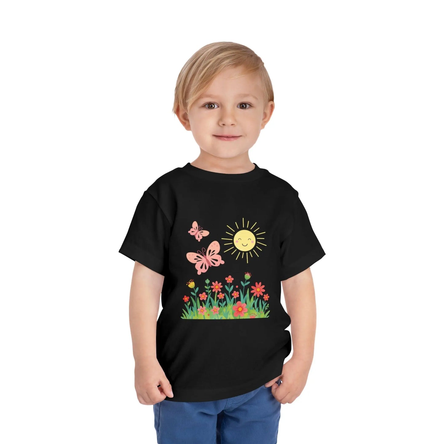 Toddler wearing a cheerful toddler tee with smiling sun, butterflies, and wildflowers. Soft cotton, perfect for spring, playdates, and outdoor adventures. Bright kids' clothing. Black
