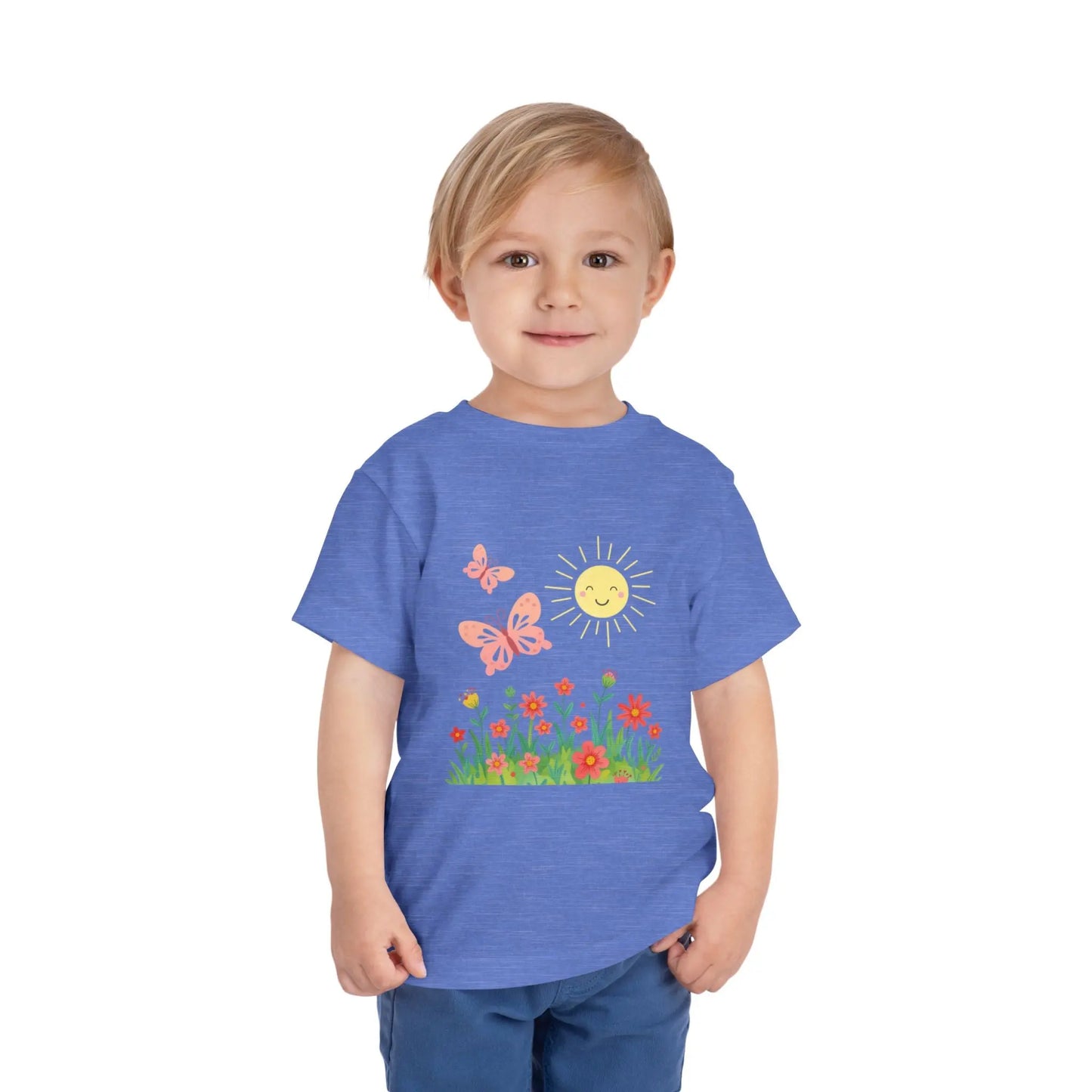 Toddler wearing a cheerful toddler tee with smiling sun, butterflies, and wildflowers. Soft cotton, perfect for spring, playdates, and outdoor adventures. Bright kids' clothing. Heather Columbia Blue