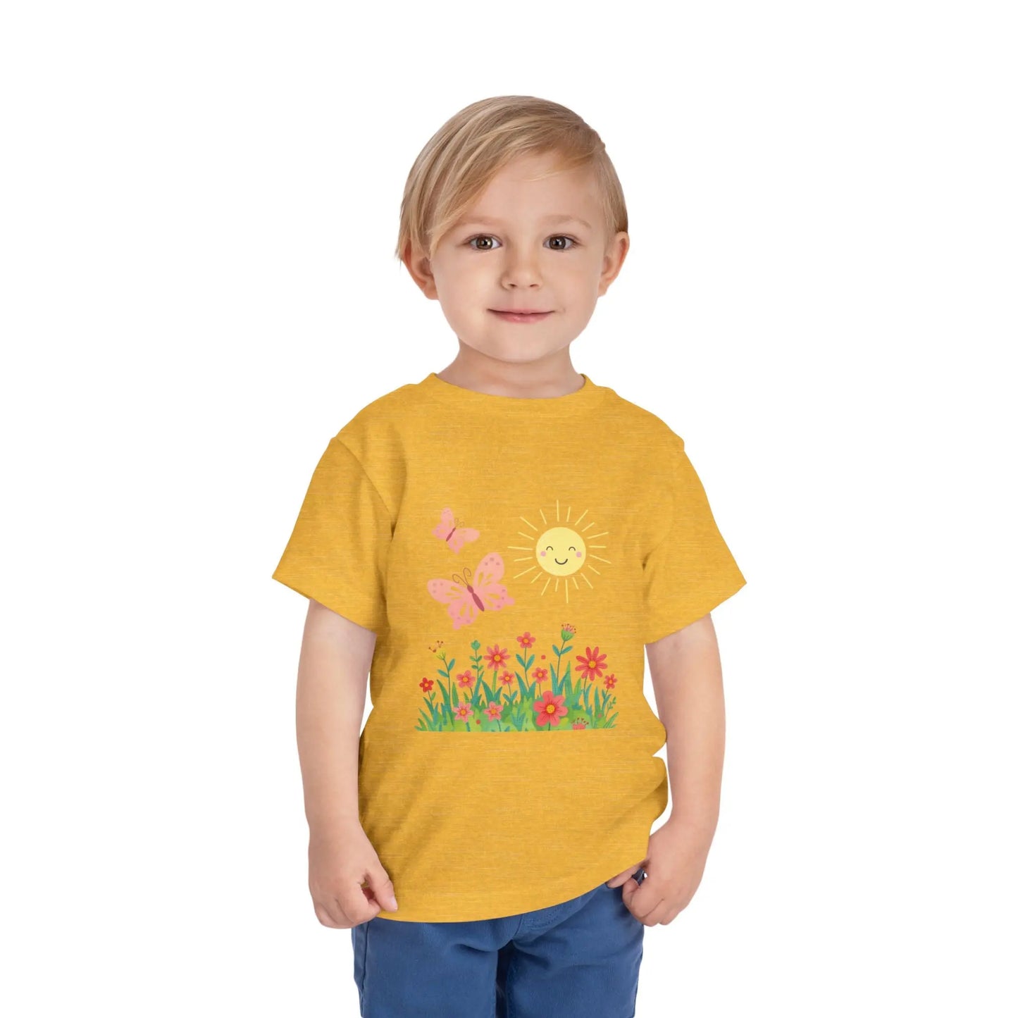 Toddler wearing a cheerful toddler tee with smiling sun, butterflies, and wildflowers. Soft cotton, perfect for spring, playdates, and outdoor adventures. Bright kids' clothing. Heather Yellow Dust