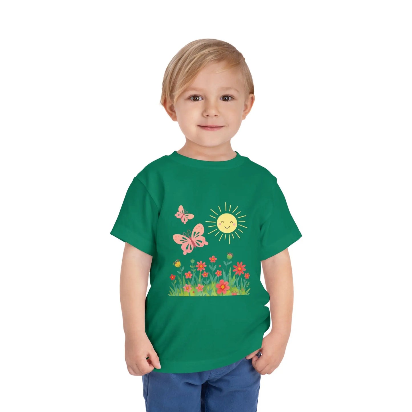 Toddler wearing a cheerful toddler tee with smiling sun, butterflies, and wildflowers. Soft cotton, perfect for spring, playdates, and outdoor adventures. Bright kids' clothing. Kelly Green