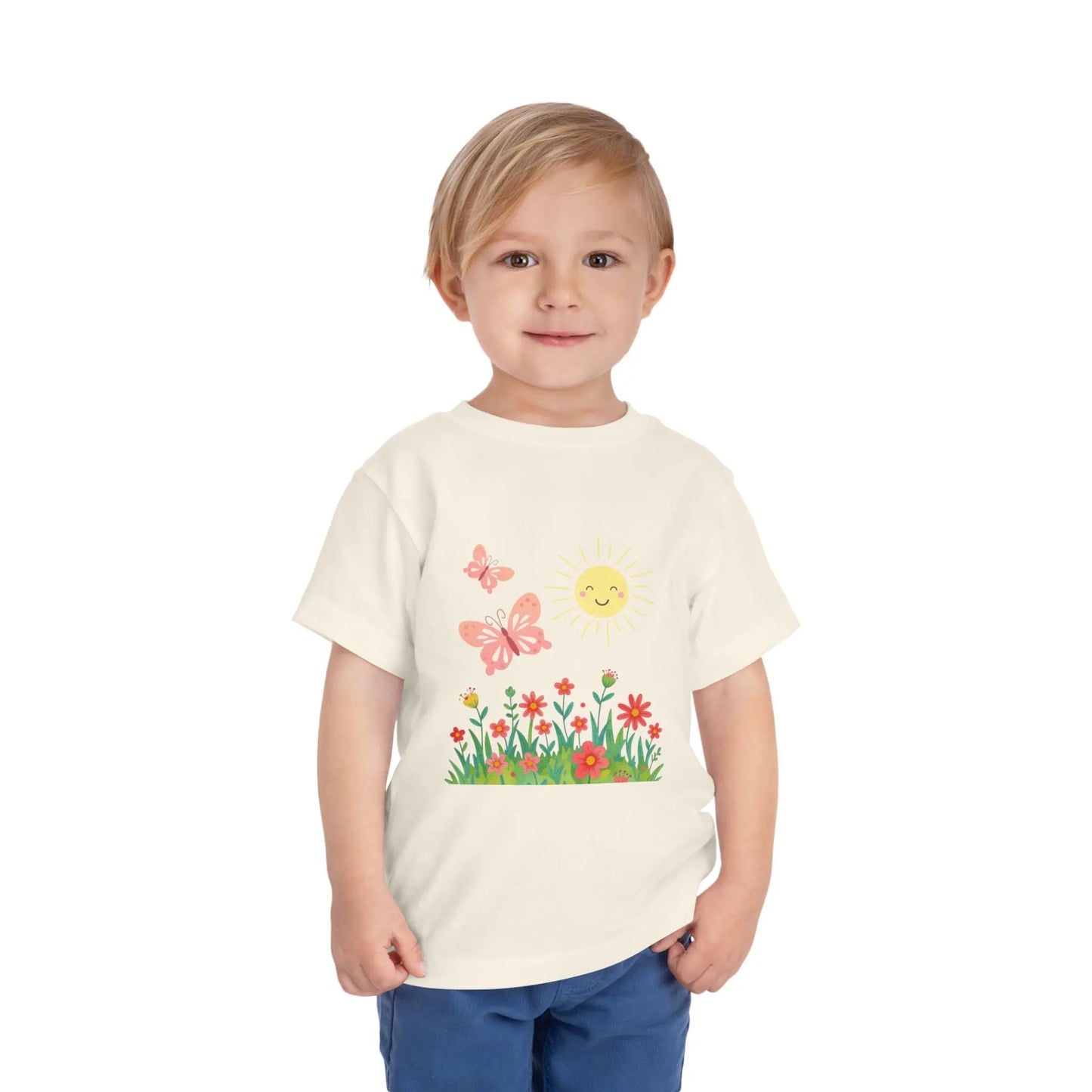 Toddler wearing a cheerful toddler tee with smiling sun, butterflies, and wildflowers. Soft cotton, perfect for spring, playdates, and outdoor adventures. Bright kids' clothing. Natural