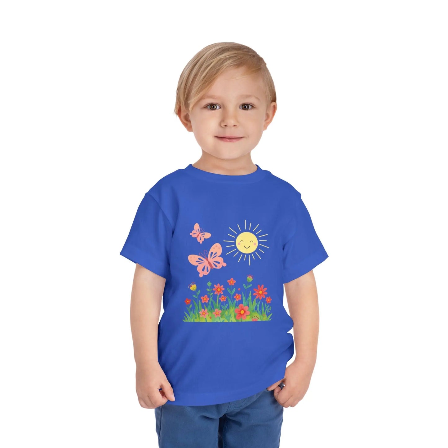 Toddler wearing a cheerful toddler tee with smiling sun, butterflies, and wildflowers. Soft cotton, perfect for spring, playdates, and outdoor adventures. Bright kids' clothing. True Royal