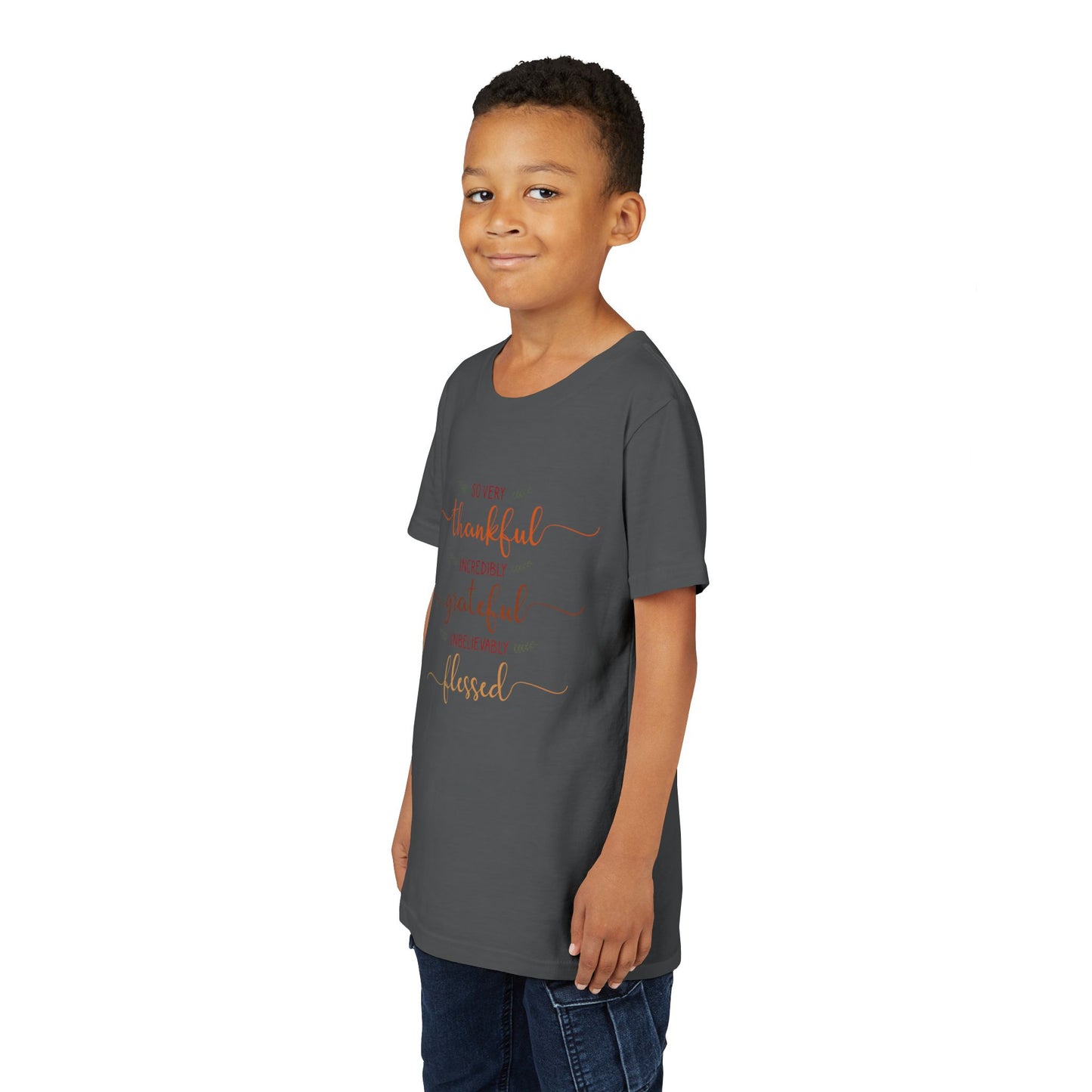 Youth wearing a heartfelt youth tee with "Thankful, Grateful, Blessed" message. Soft cotton, perfect for Thanksgiving, family photos, and everyday gratitude. Inspirational kids' clothing. Asphalt