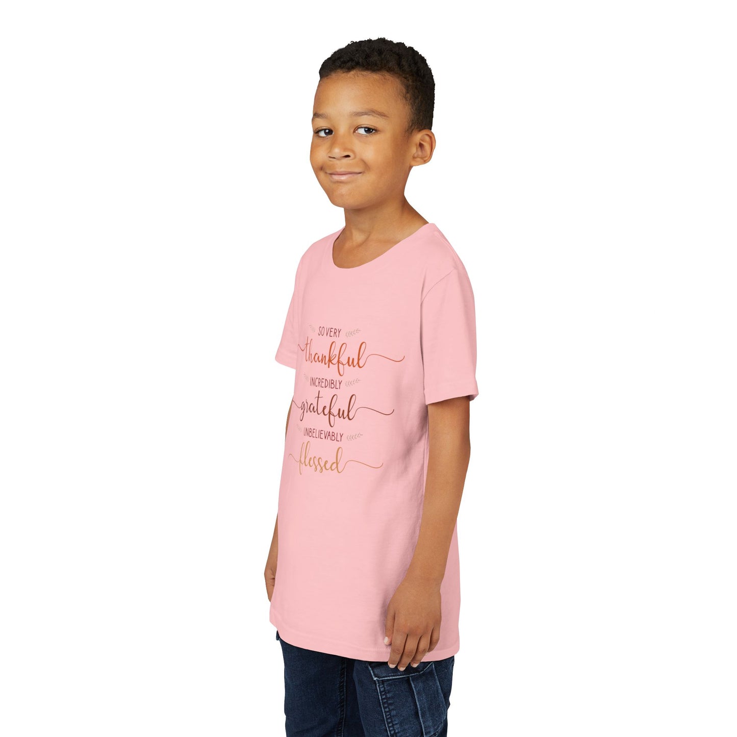 Youth wearing a heartfelt youth tee with "Thankful, Grateful, Blessed" message. Soft cotton, perfect for Thanksgiving, family photos, and everyday gratitude. Inspirational kids' clothing. Pink