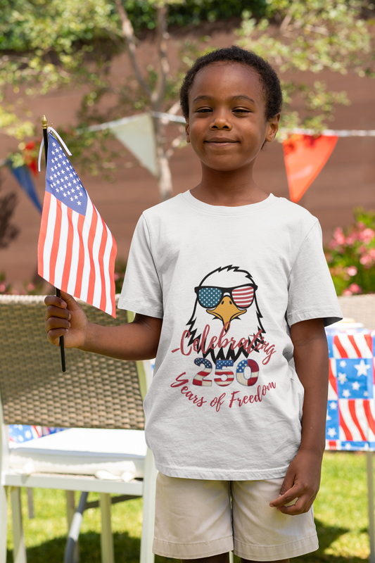 Celebrate America's 250th birthday in style! This soft Bella Canvas toddler tee features a patriotic eagle in American-flag sunglasses. Perfect for 4th of July parades, cookouts & fireworks. Sizes 2T–5T.