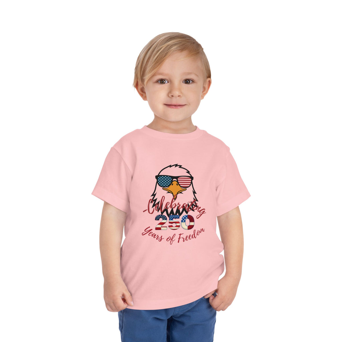Celebrate America's 250th birthday in style! This soft Bella Canvas toddler tee features a patriotic eagle in American-flag sunglasses. Perfect for 4th of July parades, cookouts & fireworks. Sizes 2T–5T. Pink