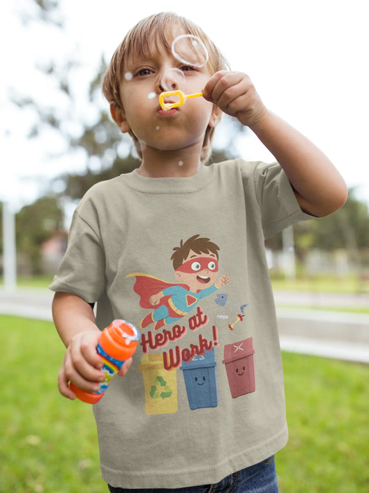 Toddler wearing these inspiring little eco-heroes with this playful toddler recycling shirt. Soft, durable cotton tee featuring a caped superhero sorting bin. Perfect for Earth Day, preschool, and everyday adventures. Heather Stone