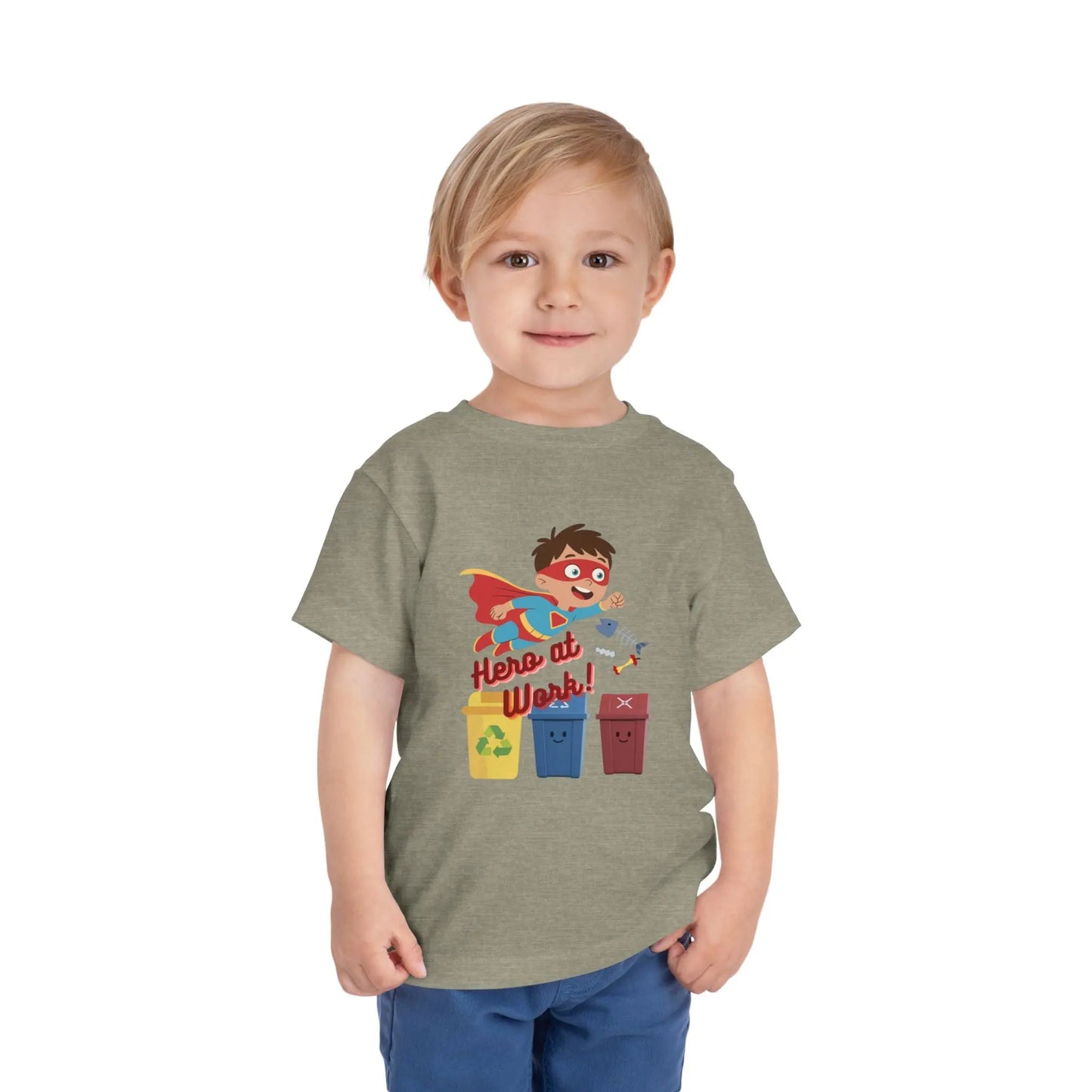 Toddler wearing these inspiring little eco-heroes with this playful toddler recycling shirt. Soft, durable cotton tee featuring a caped superhero sorting bin. Perfect for Earth Day, preschool, and everyday adventures. Heather Stone