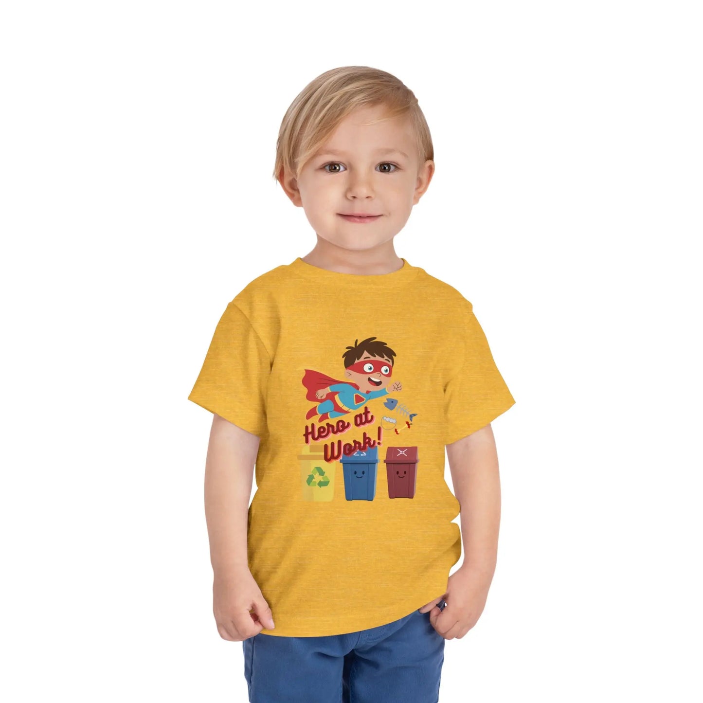 Toddler wearing these inspiring little eco-heroes with this playful toddler recycling shirt. Soft, durable cotton tee featuring a caped superhero sorting bin. Perfect for Earth Day, preschool, and everyday adventures. Heather Yellow Gold
