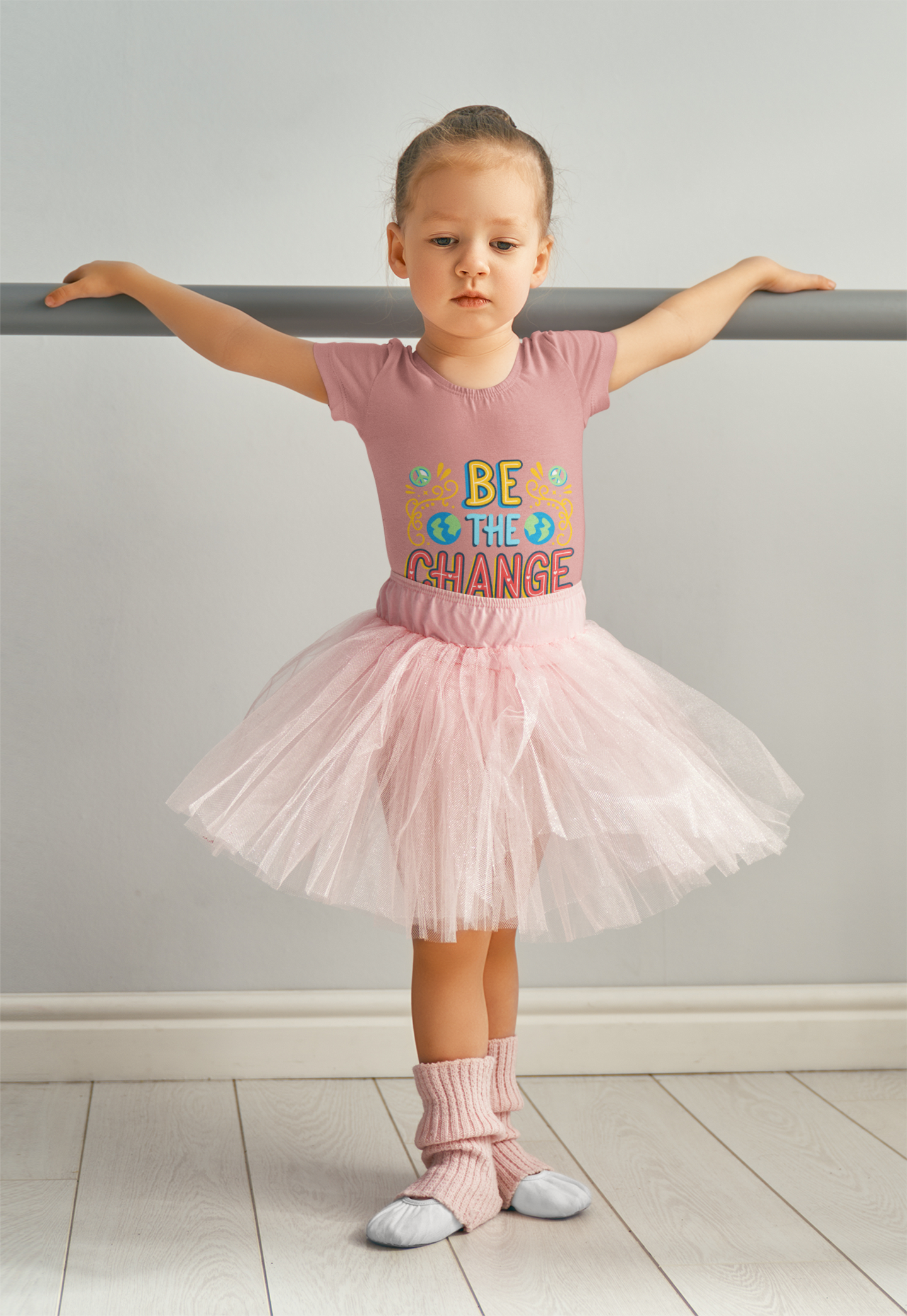 Toddler wearing Be the Change tee with globe icons and hand-drawn lettering, Heather Mauve
