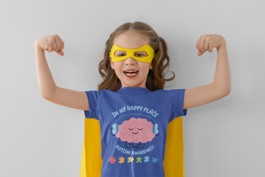 Child wearing a superhero costume with a 'Happy Place' t-shirt on a plain background. Shop our comfortable Toddler Tee featuring "In My Happy Place" autism awareness design, perfect for preschool and toddler kids.