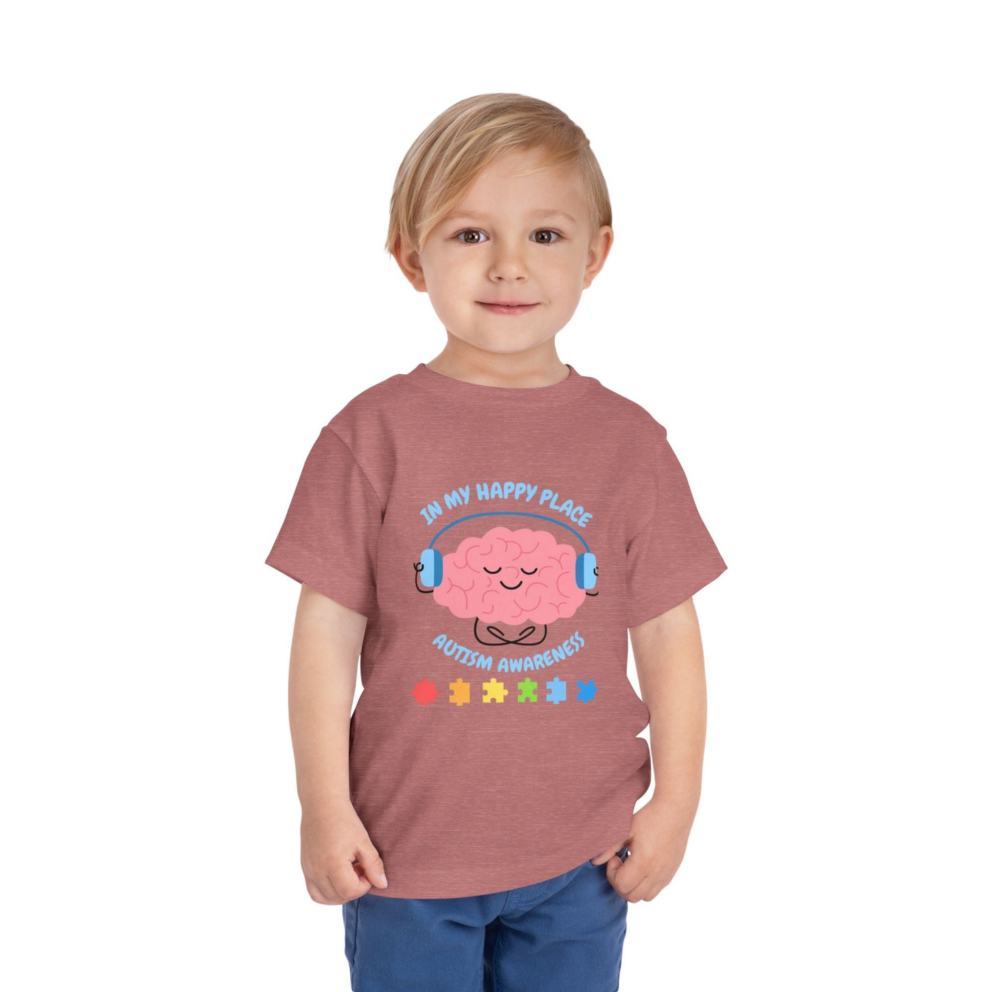 Child wearing a t-shirt with a brain graphic and text on a white background. Shop our comfortable Toddler Tee featuring "In My Happy Place" autism awareness design, perfect for preschool and toddler kids. Heather Mauve