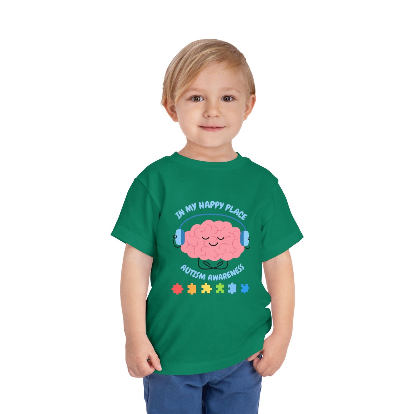 Child wearing a green t-shirt with a brain graphic and text on a white background. Shop our comfortable Toddler Tee featuring "In My Happy Place" autism awareness design, perfect for preschool and toddler kids. Kelly Green