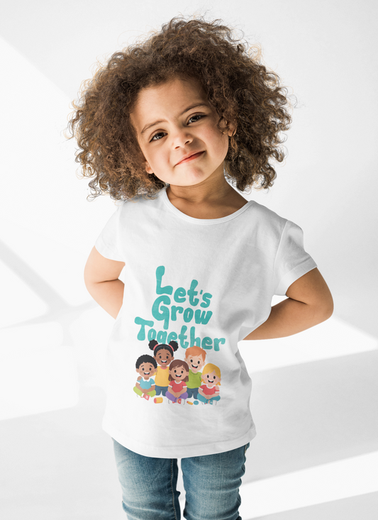 Toddler wearing Let's Grow Together tee with multicultural smiling faces design white
