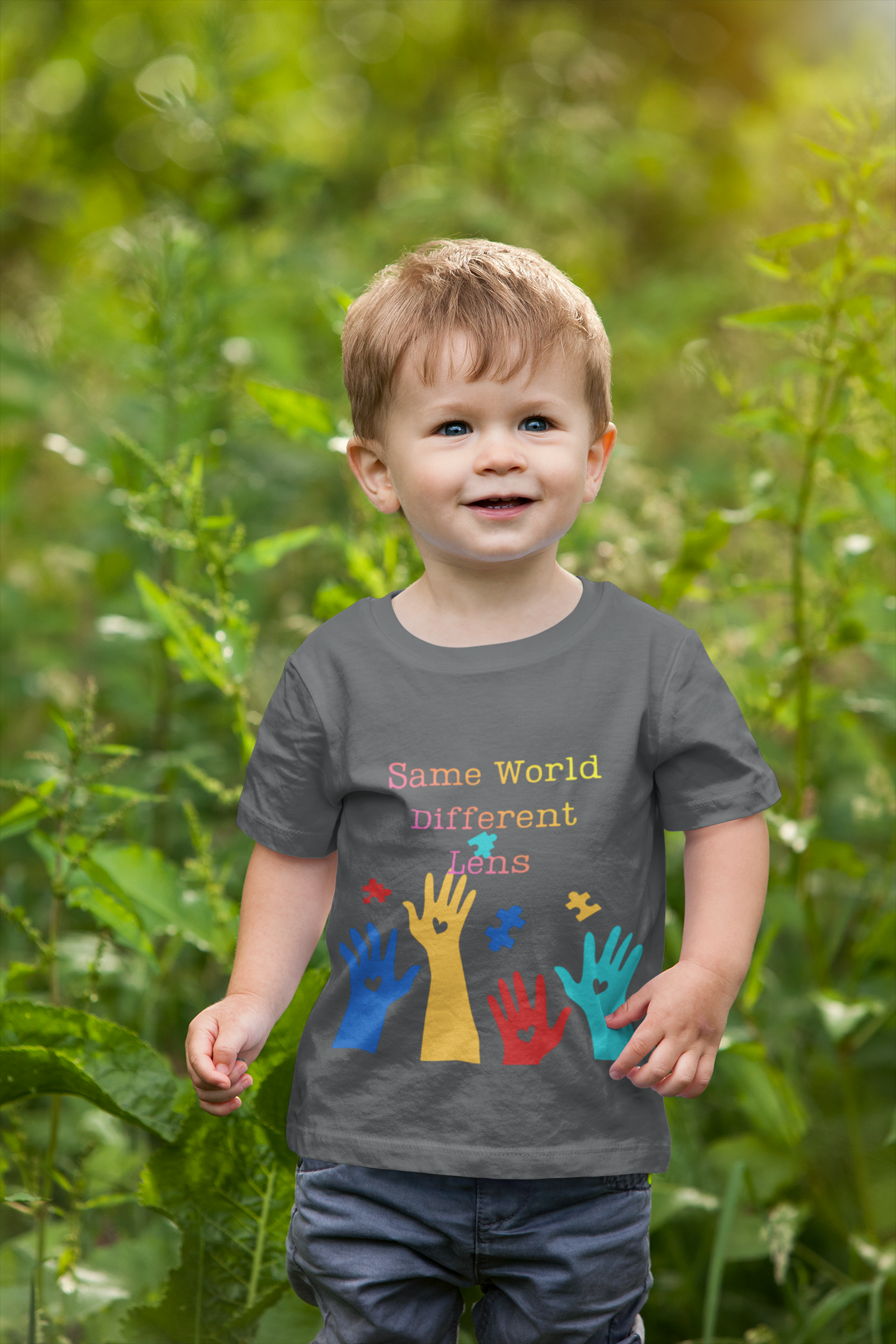Toddler wearing Same World Different Lens tee with colorful handprints and autism awareness design, Asphalt
