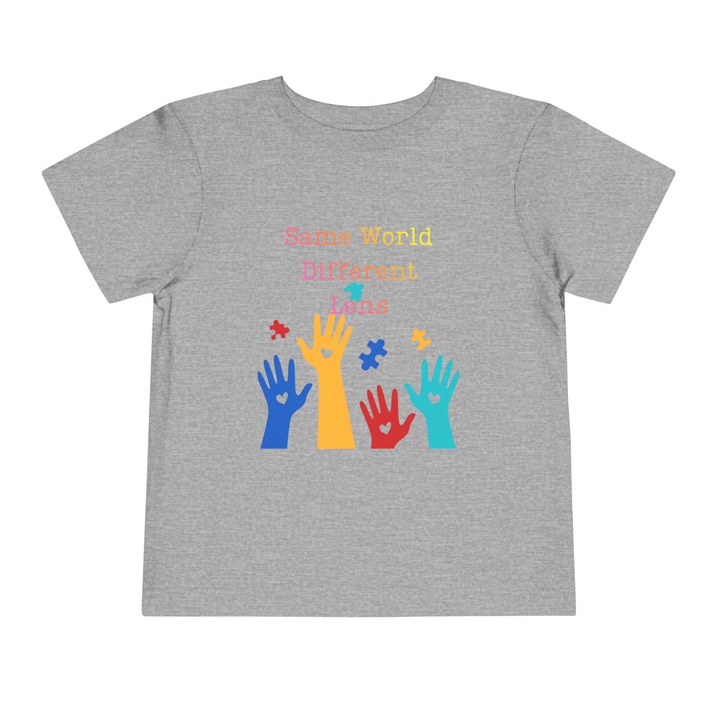Soft cotton toddler tee with colorful hands, puzzle pieces, and Built Differently message. Celebrates neurodiversity and inclusion. Sizes 2T-5T. Athletic Heather
