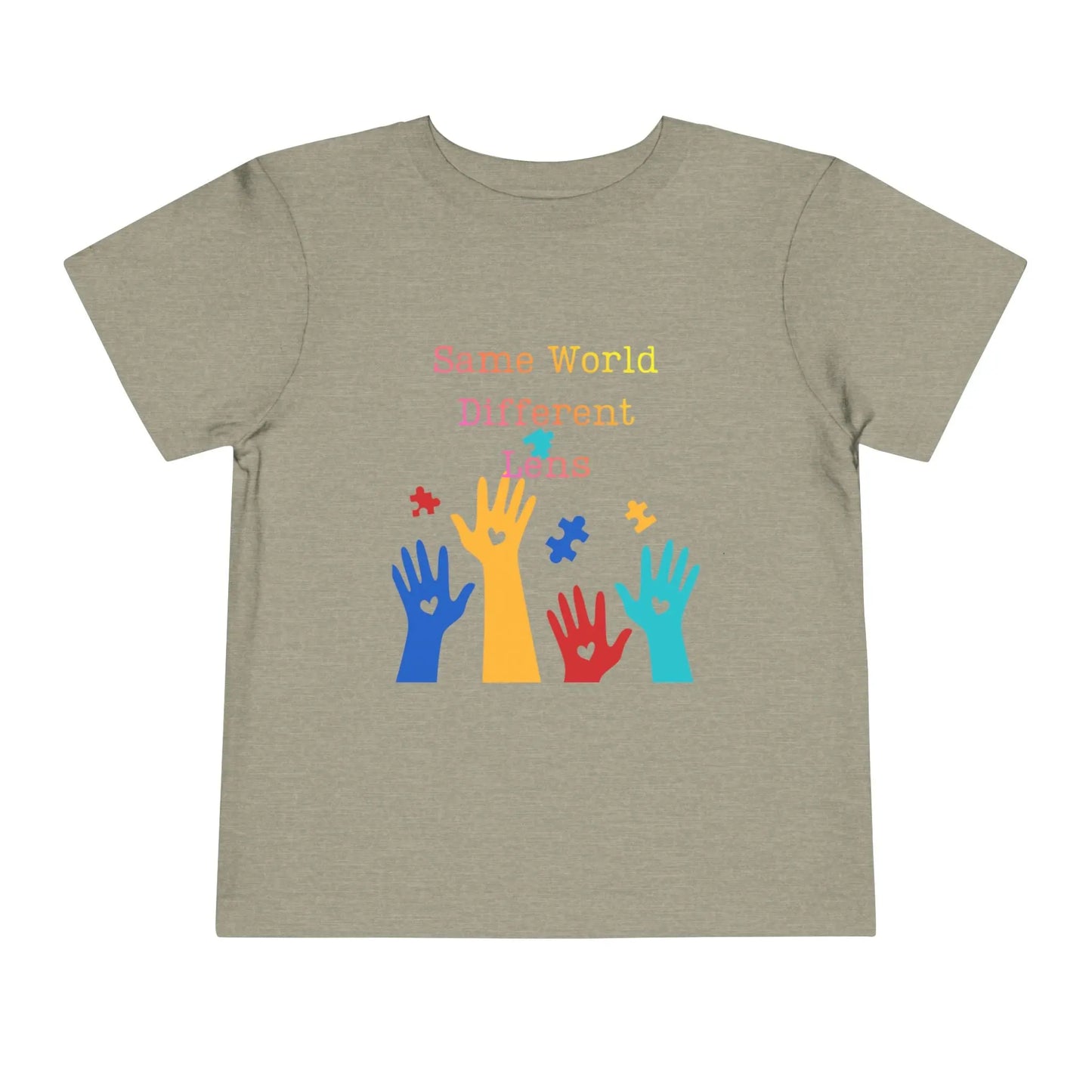 Soft cotton toddler tee with colorful hands, puzzle pieces, and Built Differently message. Celebrates neurodiversity and inclusion. Sizes 2T-5T. Heather Stone
