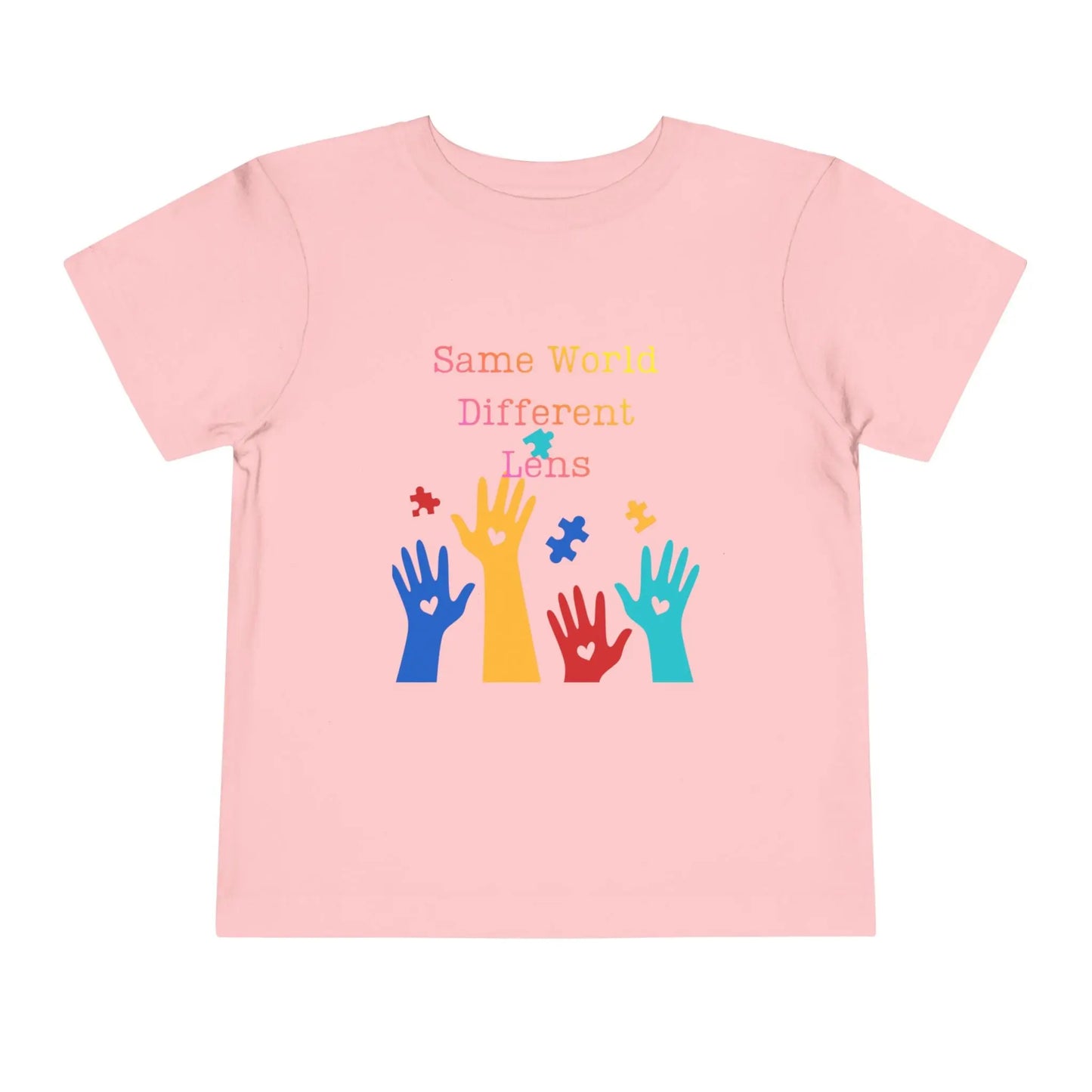Soft cotton toddler tee with colorful hands, puzzle pieces, and Built Differently message. Celebrates neurodiversity and inclusion. Sizes 2T-5T. Pink
