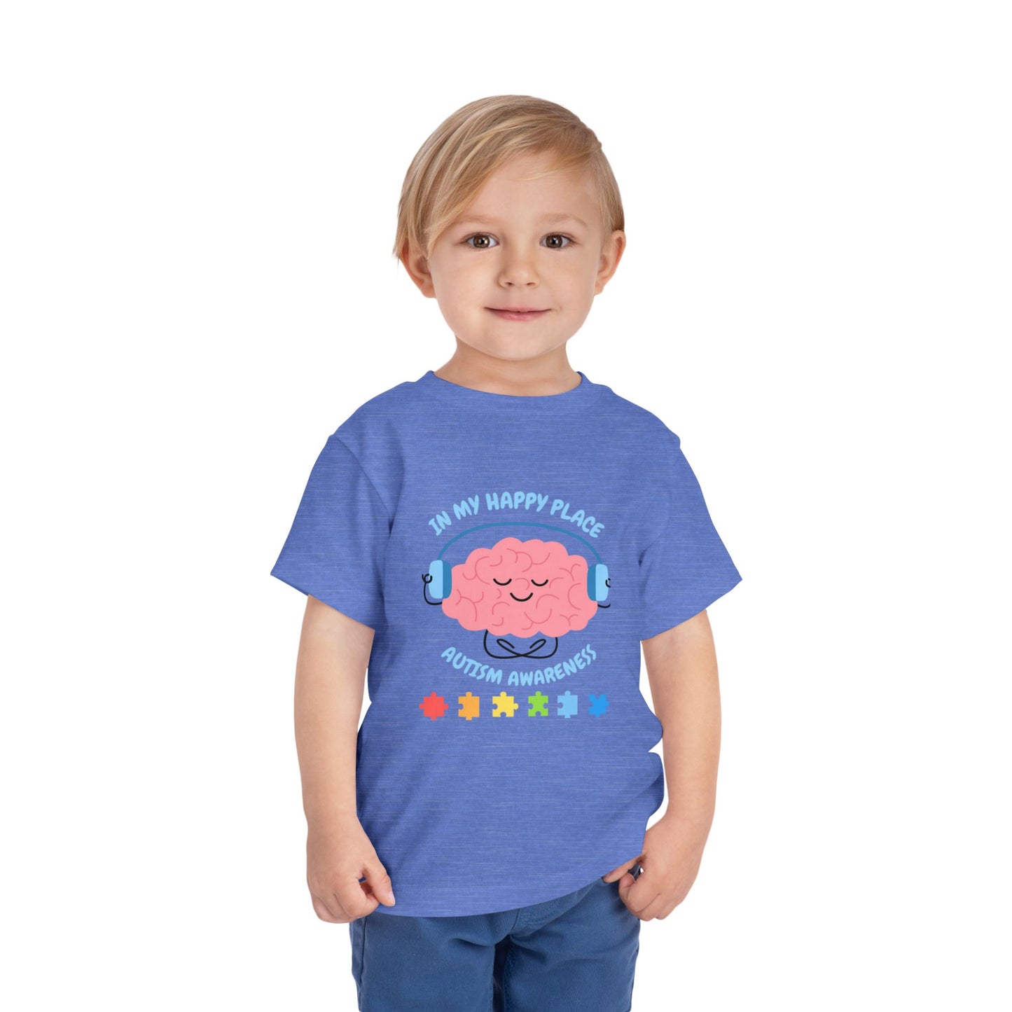 Child wearing a blue t-shirt with a brain graphic and text on a white background. Shop our comfortable Toddler Tee featuring "In My Happy Place" autism awareness design, perfect for preschool and toddler kids. Heather Columbia Blue