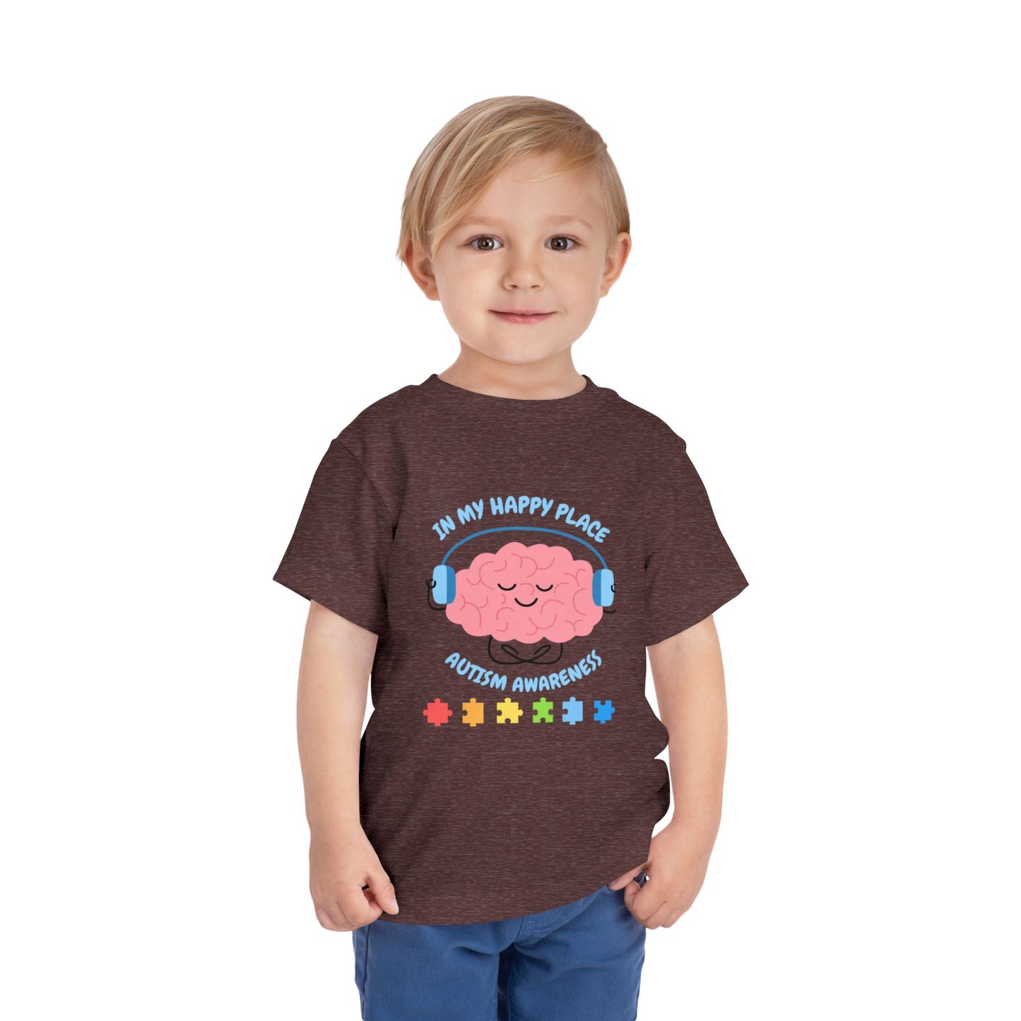 Child wearing a t-shirt with autism awareness design on a white background. Shop our comfortable Toddler Tee featuring "In My Happy Place" autism awareness design, perfect for preschool and toddler kids. Heather Maroon