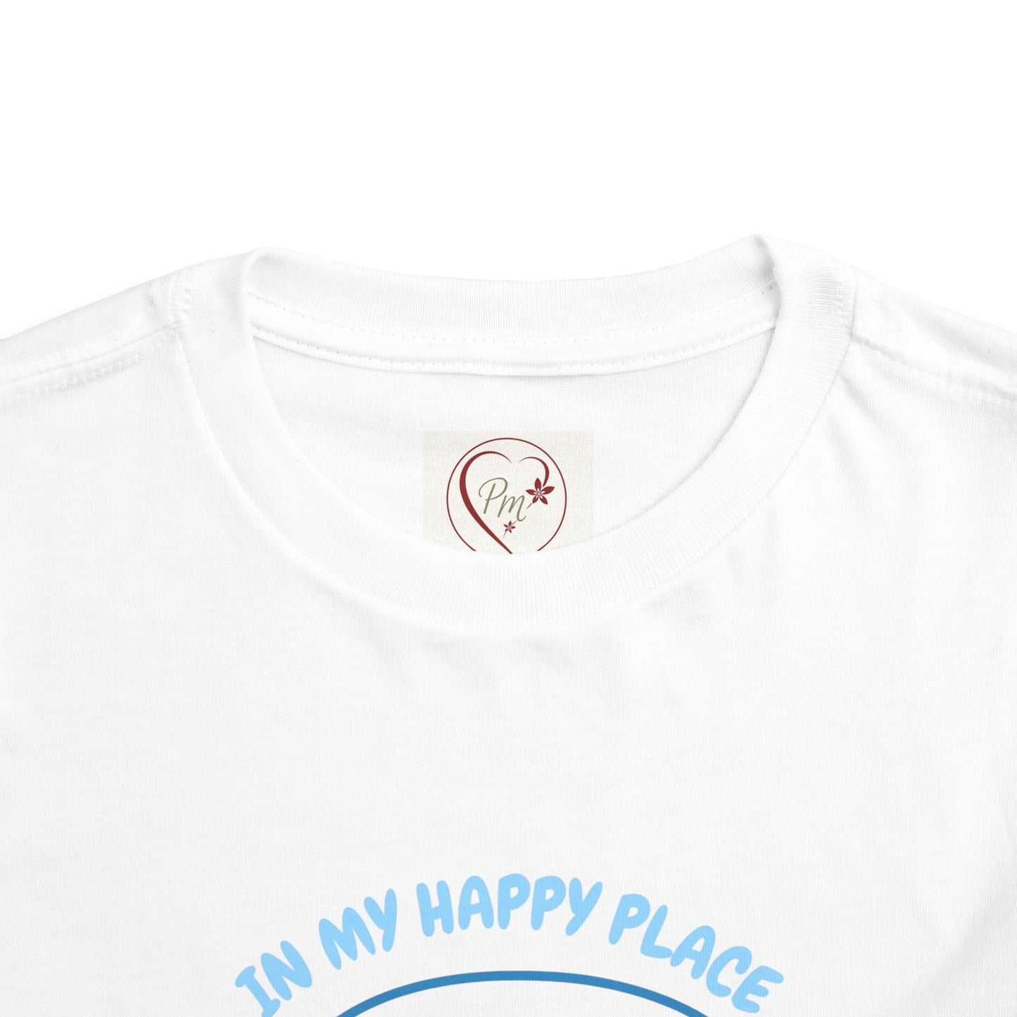 White t-shirt with 'In My Happy Place' text and a PM Creations 25 logo on a white background