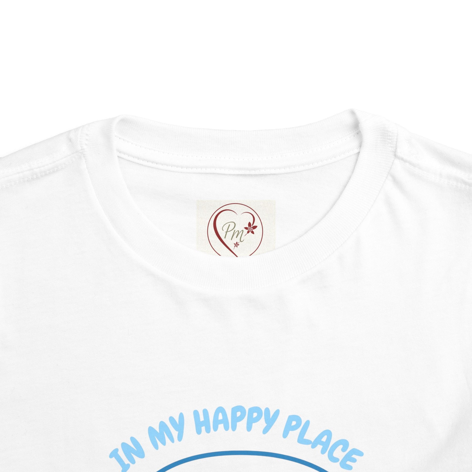 White t-shirt with 'In My Happy Place' text and a PM Creations 25 logo on a white background