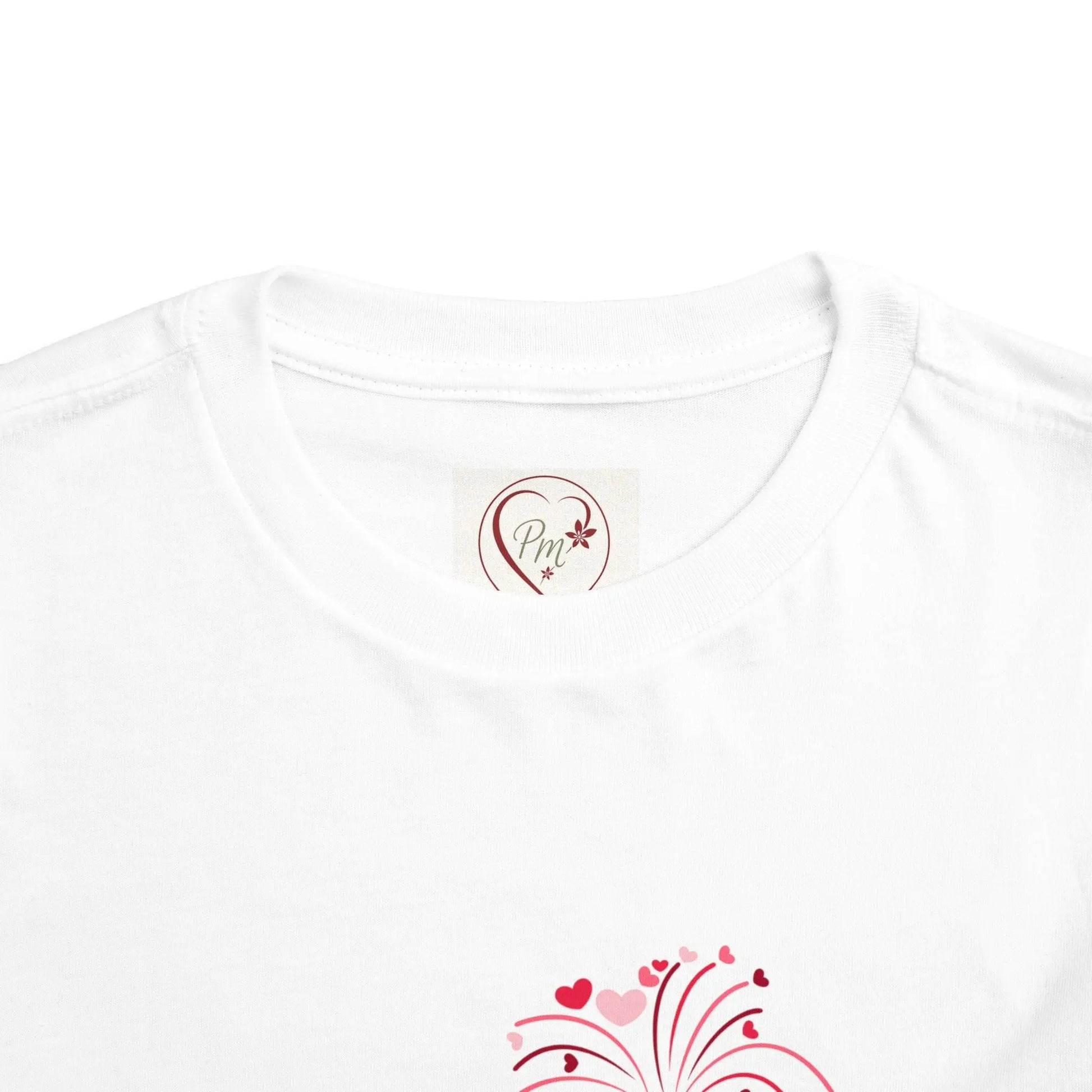 White t-shirt with a heart-shaped PM Creations 25 logo and decorative elements on a white background