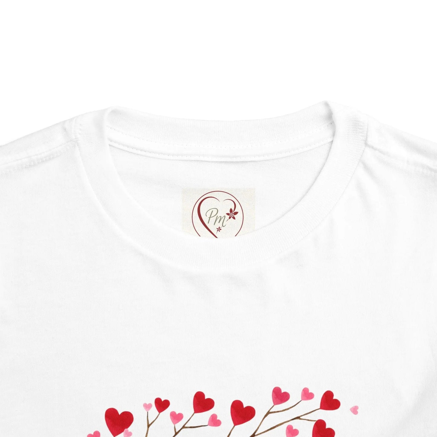 White t-shirt with a heart-shaped PM Creations 25 logo and red heart designs on a white background