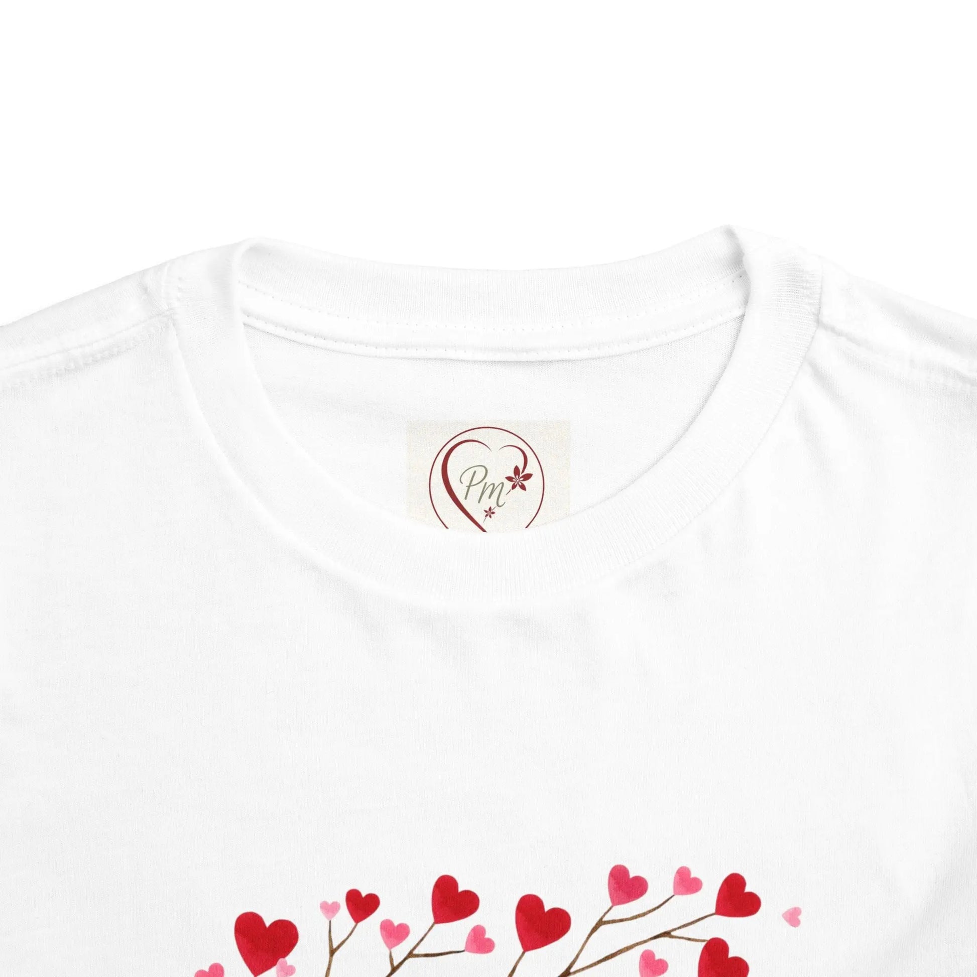 White t-shirt with a heart-shaped PM Creations 25 logo and red heart designs on a white background