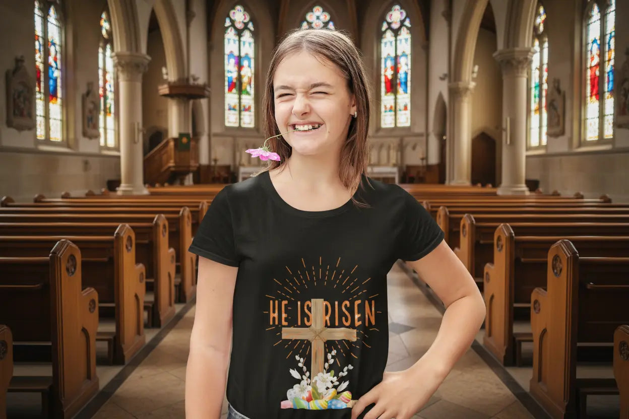 Youth wearing, He Is Risen Easter tee with cross, lilies, and pastel eggs graphic, Black
