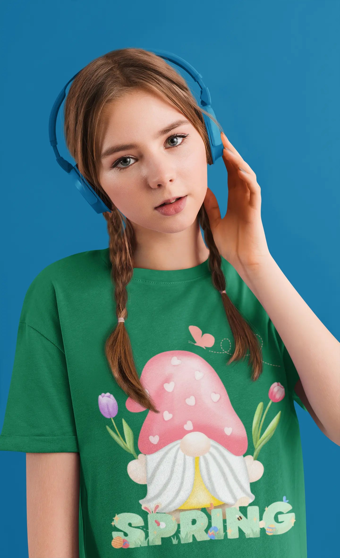 Youth wearing spring gnome tee with mushroom gnome, tulips, and bluebird graphic, kelly green
