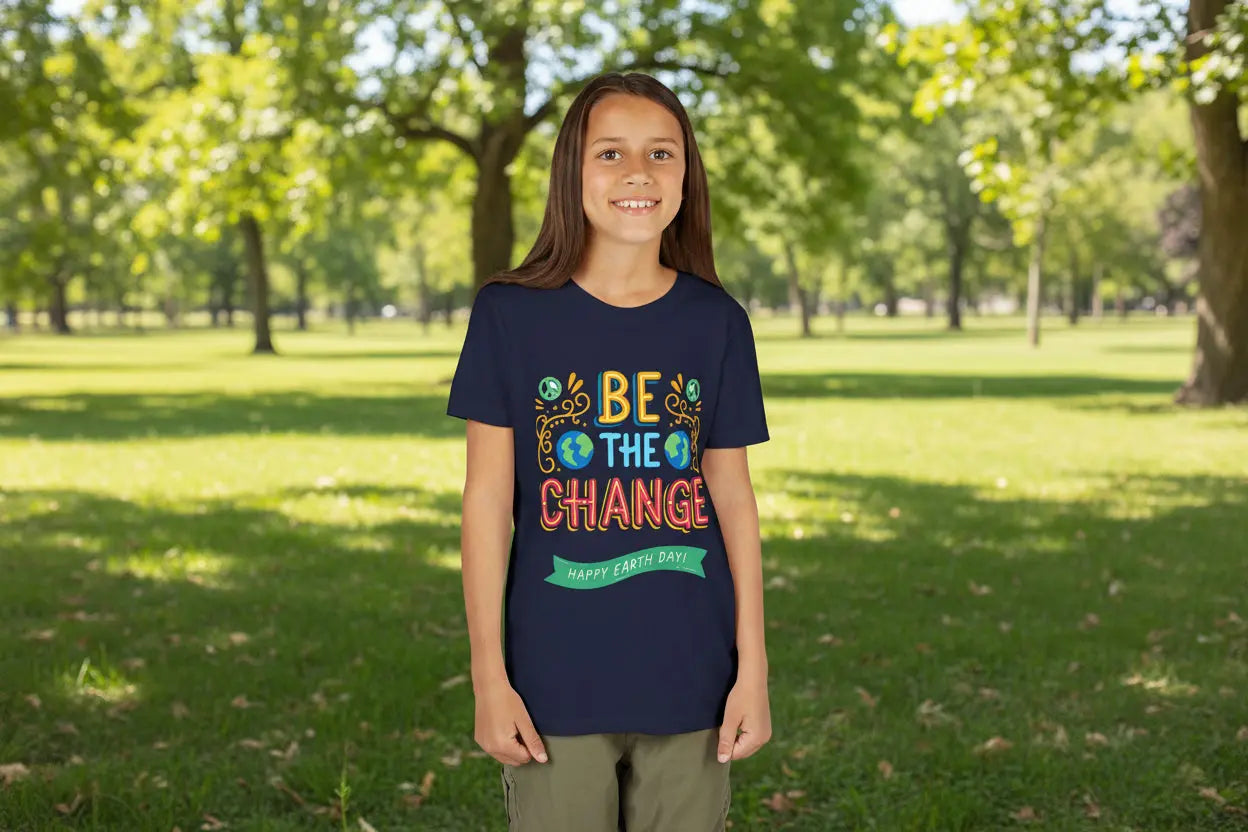 Youth wearing Be the Change tee with Earth Day globe and sunburst design,
Navy