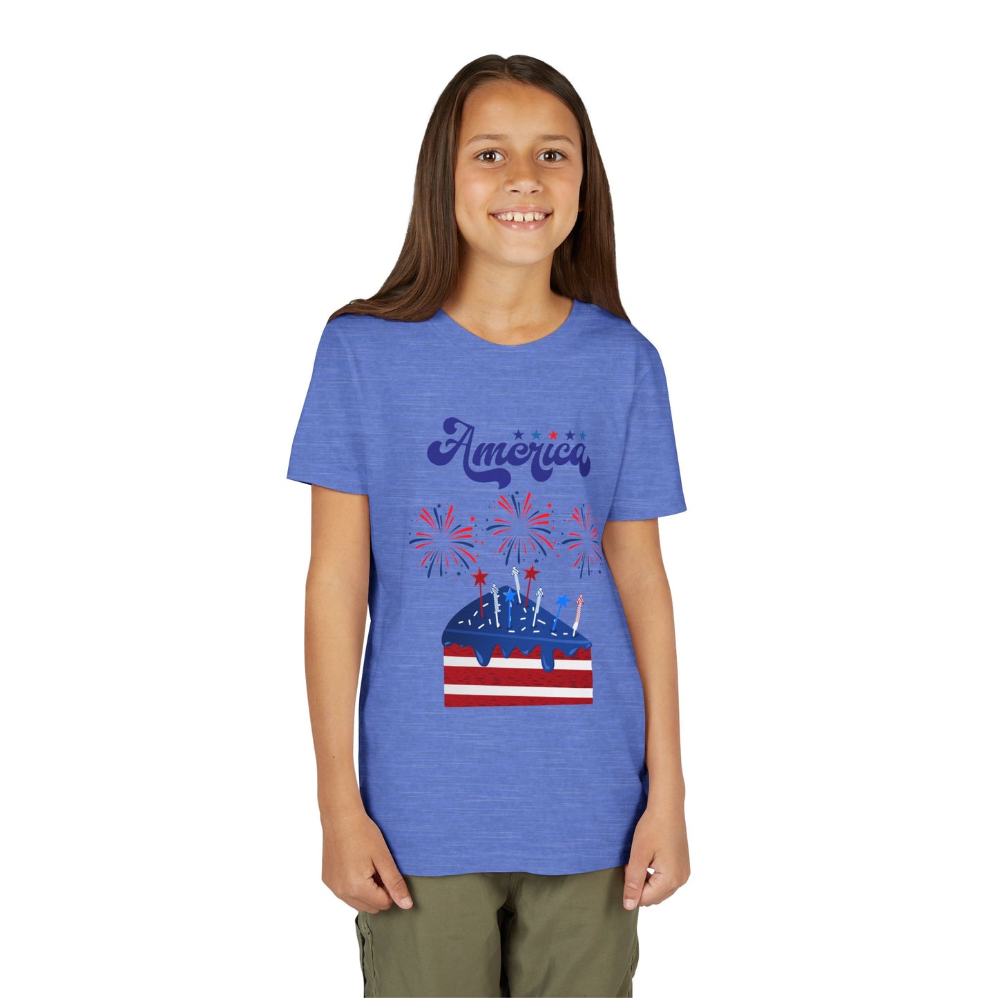 Girl wearing a Heather Columbia Blue t-shirt with 'America' and a graphic design on a white background. Celebrate the 4th of July in style! This patriotic America fireworks youth tee is perfect for kids who love Independence Day festivities and summer fun.